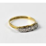 An 18ct yellow gold ladies' dress ring set with five small diamonds in heart-shaped platinum