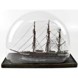 A model of a 19th century three-masted sailing ship, on painted gently lapping waves,