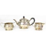 A George V hallmarked silver three-piece tea service of circular form,