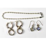 A silver fine twist bracelet, a pair of silver drop earrings set with moonstones,