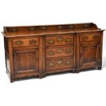 A George III style oak break-front sideboard comprising galleried back of three drawers above