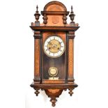 A mahogany Vienna wall clock, the ivorine chapter ring set with Roman numerals,
