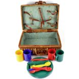 A vintage wicker picnic basket with later contents,