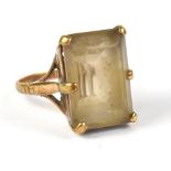 A 9ct gold ring set with baguette cut smoky quartz in a six-claw openwork setting, stamped 9ct,