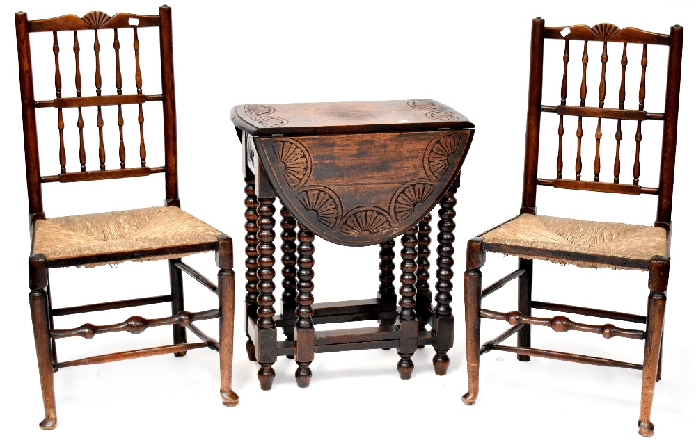 An early 20th century oak gateleg side table with bobbin turned supports,