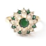 A 9ct gold flower cluster ring with central green stone above a ring of small claw set white stones,