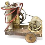 A vintage Burtonwood portable compressor with electric motor driving a flywheel to a compressor and