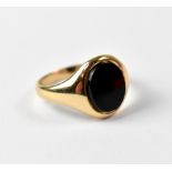 A 9ct yellow gold ring set with a later onyx stone, approx 3.3g.