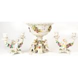A 20th century porcelain comport with pierced basket encrusted with flowers,