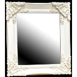 A modern Rococo-style cream painted wall mirror of rectangular form, 86 x 74cm.