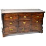 An early 19th century oak mule chest, lift-up top above six faux doors,