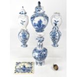 A collection of mainly early 20th century blue and white Delft ware to include a pair of baluster