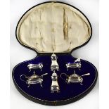 A cased George V hallmarked silver six-piece cruet, salt and pepper pots, two mustard pots,