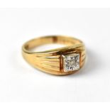 A 9ct yellow gold gentlemen's dress ring, solitaire diamond in sunburst setting, size V 1/2,
