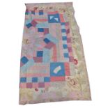 A late 19th century child's homemade patchwork bedcover with various shaped stitched panels,