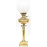 An Edwardian brass oil lamp with brass oil reserve,