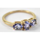 A 10ct yellow gold ring set with three graduated tanzanites, size N, approx 1.9g.