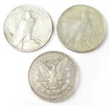 Three USA silver dollars to include silver Peace dollars, 1921 and 1922,