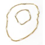 A 9ct gold necklace with elongated links separated by a short run of belcher links,