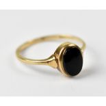 A 9ct yellow gold ladies' dress ring set with oval onyx stone, approx 1.8g.