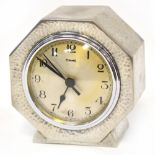 FERRANTI; an Art Deco style beaten pewter clock, the silvered dial set with Arabic numerals,