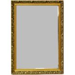 A contemporary gilt framed mirror with bevelled plate and embossed foliate decoration, 49 x 75cm.