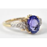 A 10ct yellow gold ring set with tanzanite and chip cubic zirconium to the shoulders, size L,
