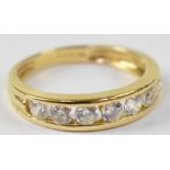 A 18ct yellow gold ring set with seven white stones, size M1/2, approx 3.2g.
