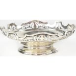 A George V hallmarked silver bowl with pierced scroll border, raised on a circular foot,
