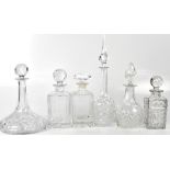 Six 20th century cut glass decanters comprising three square decanters, a globular decanter,