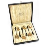 A cased set of six silver gilt enamelled teaspoons, with gilt-heightened decoration, Kristian M.