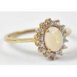 A 9ct yellow gold ring set with central opal surrounded by cubic zirconium, size N, approx 2g.