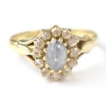 A 9ct gold fashion ring with central blue stone, possibly aquamarine,