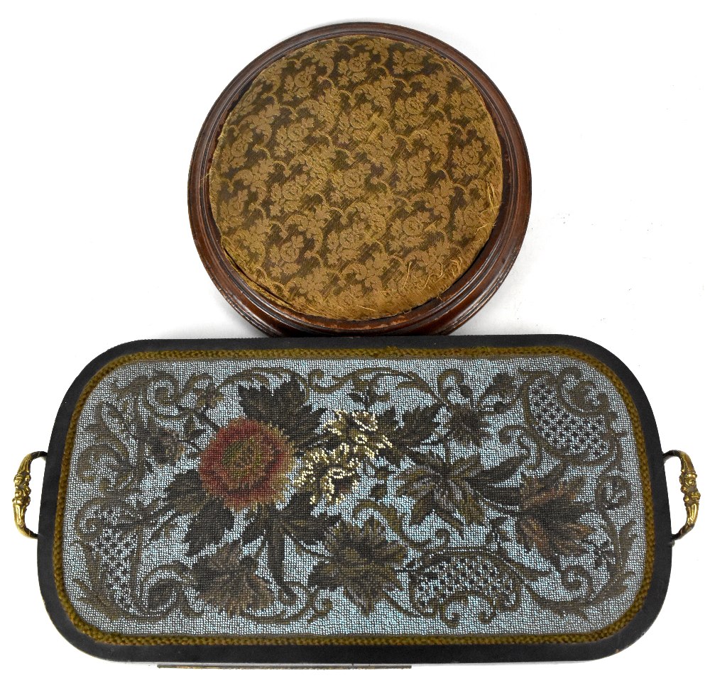 A late 19th century German beadwork tray in black lacquered frame and gilt brass handles,