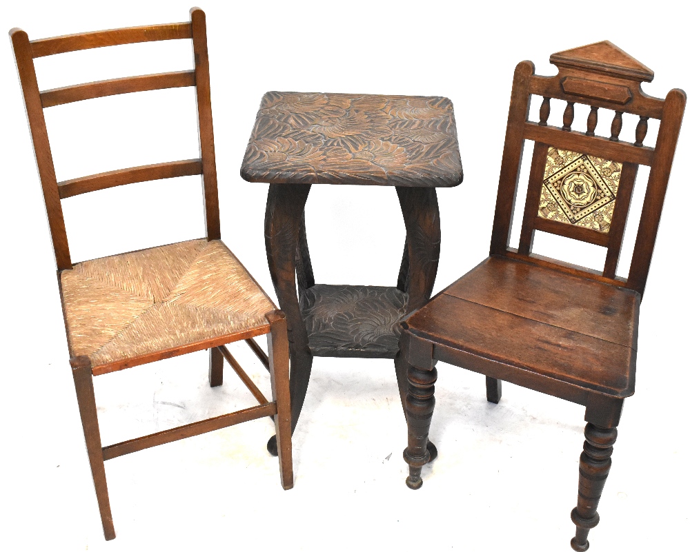 A late Victorian oak hall chair with tiles set to the back,