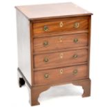 A 19th century mahogany four-drawer chest with ivory escutcheons, to shaped curving plinth,