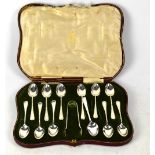 A George V hallmarked silver cased set of eleven matching teaspoons and one non-matching teaspoon