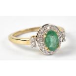 A 10ct yellow gold ring set with central emerald surrounded by white stones, size L, approx 2.4g.
