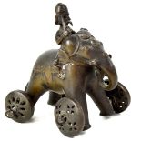 A 19th century small Indian-style bronze temple toy composed as a wheeled elephant and figure sat