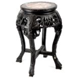 A late 19th/early 20th century Oriental carved hardwood jardinière stand of typical form,