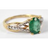 A 10ct yellow gold ring emerald, with chip cubic zirconium to the shoulders, size L, approx 2.1g.
