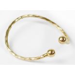 A 9ct yellow gold twist bangle, approx 5.8g.