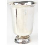 An early 19th century French silver cup of flared form, raised on a circular foot, inscribed 'M. J.