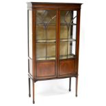 A late Victorian/early Edwardian mahogany bow-front display cabinet with string inlay,