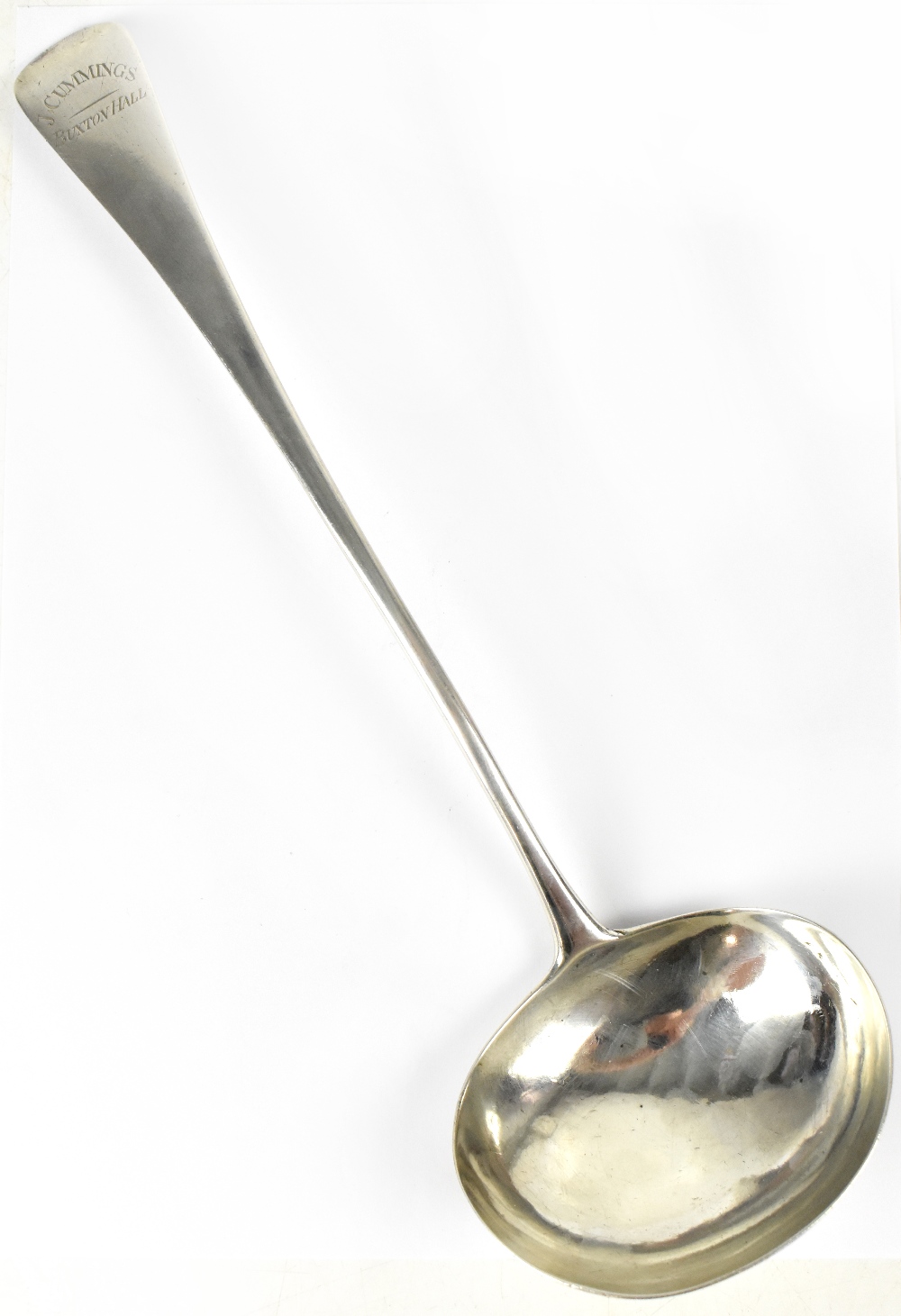 A hallmarked silver soup ladle inscribed to the top 'J.