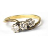 An 18ct gold three-stone diamond ring, three claw set brilliant cut diamonds, each approx 0.