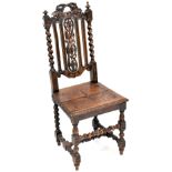 A 19th century oak carved high back hall chair with overall grape and vine carved decoration to the