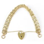 A 9ct gold five bar gate bracelet, stamped 375, with heart-shaped padlock, stamped 375, approx 15g.