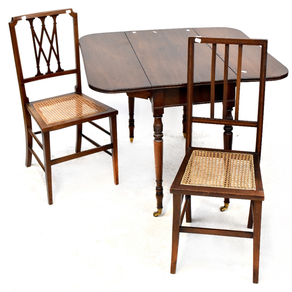 A 19th century mahogany drop-leaf table to turned tapering supports and castors,