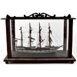 A late 19th/early 20th century scratch-built model of a four-masted sailing ship with furled sails,